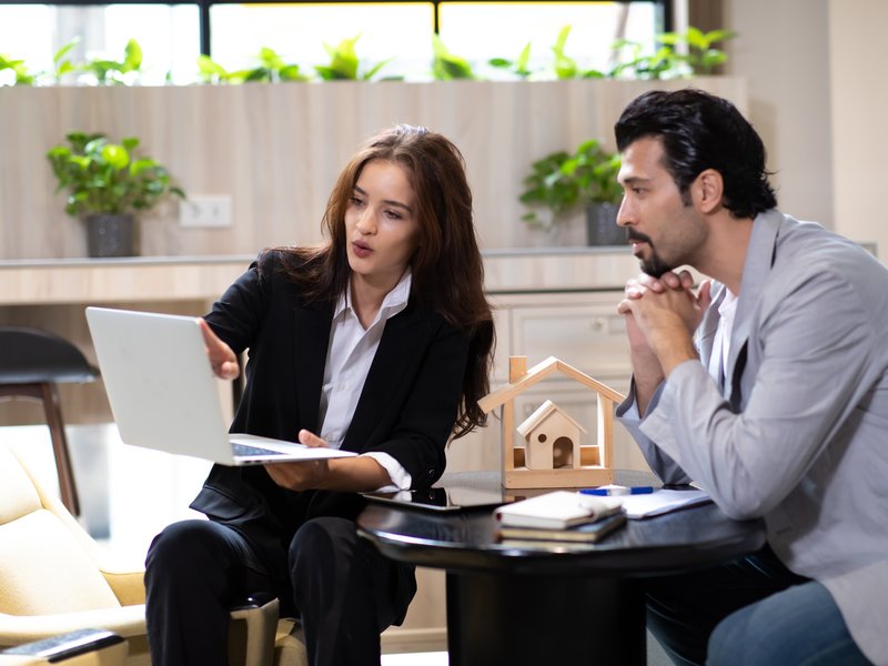 men and women looking at financing paper in San Marcos, CA