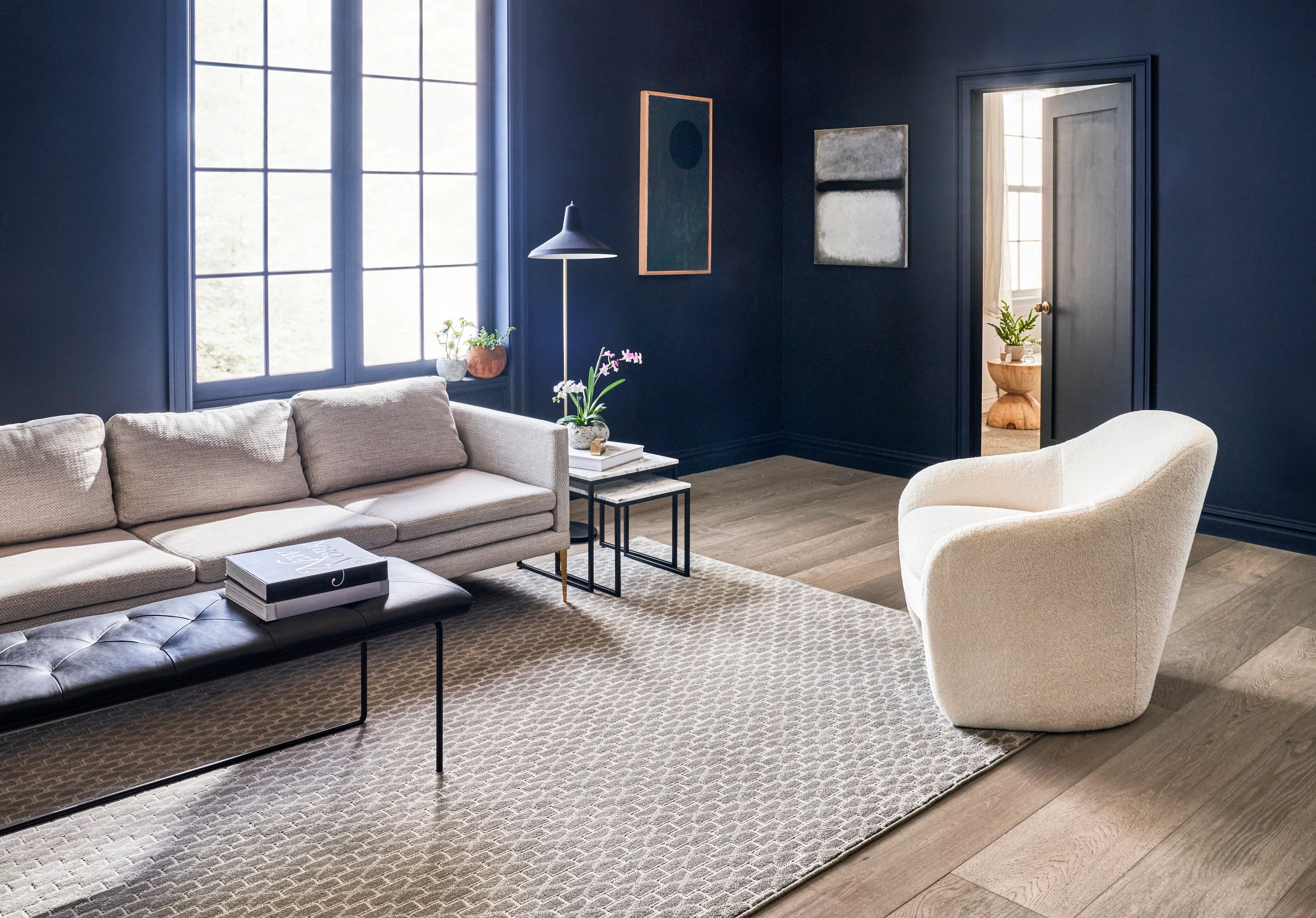 living room with white armchair and gray sofa on a beige area rug from Kenny's Custom Flooring Inc. in San Marcos, CA