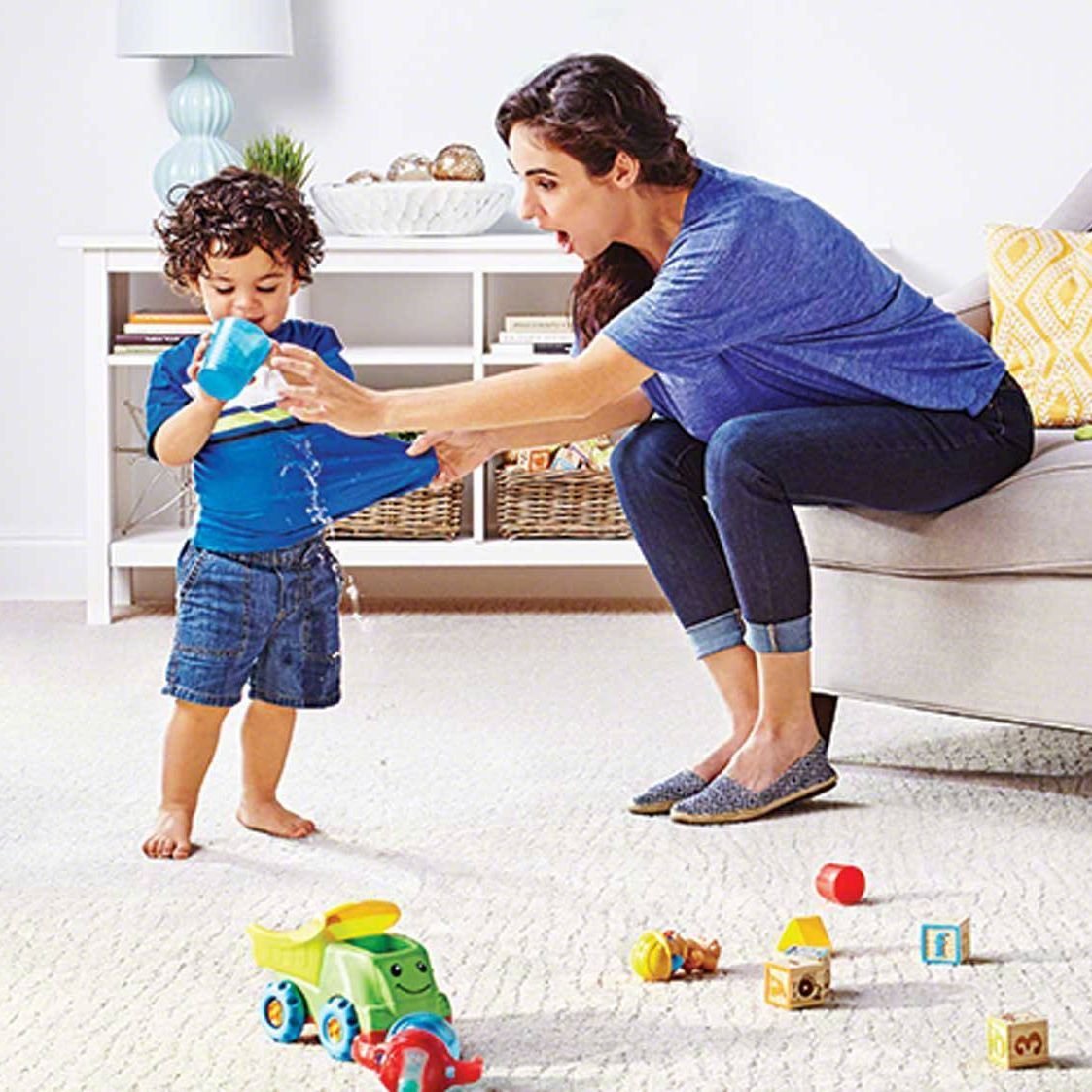 woman and kid playing in living room on a white carpet floor from Kenny's Custom Flooring Inc. in San Marcos, CA