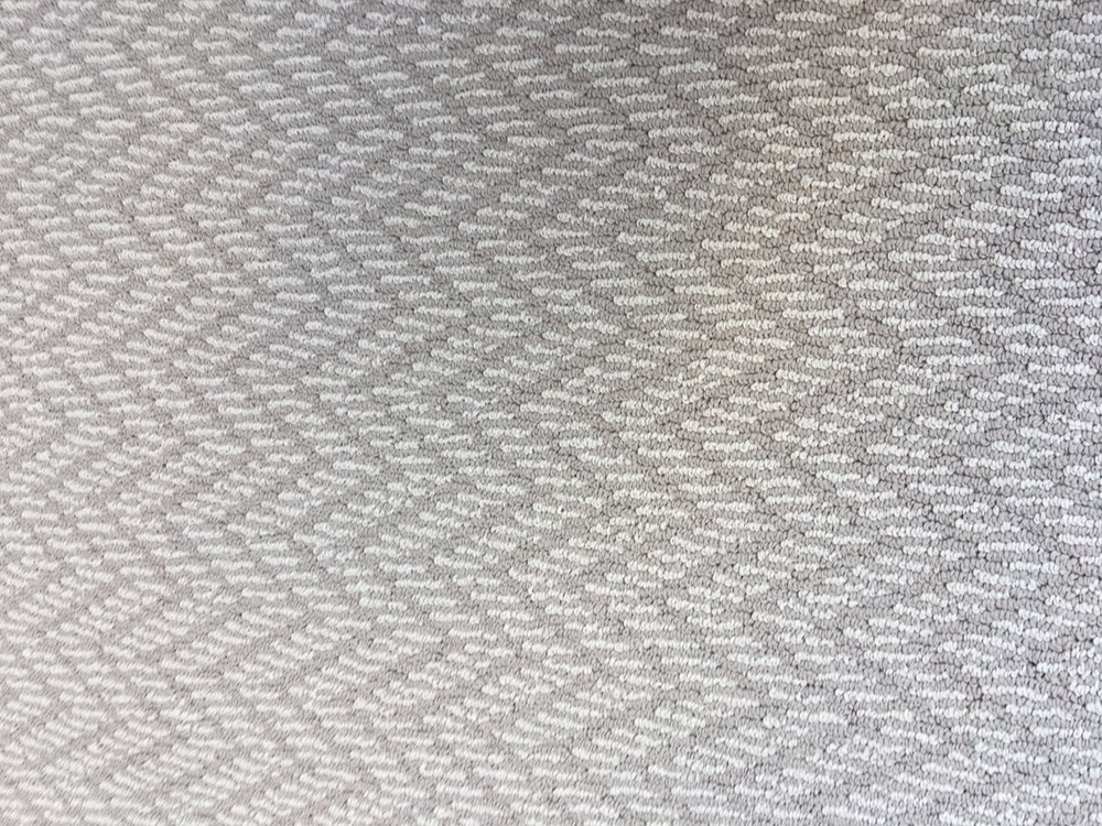 striped white and beige carpet with a zig-zag pattern