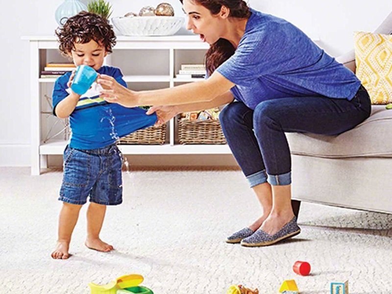 woman and kid playing in living room on a white carpet floor from Kenny's Custom Flooring Inc. in San Marcos, CA